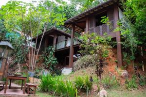 a house in the middle of a forest at Pousada Vila de Charme in Lençóis