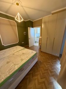 a bedroom with a bed and a closet and a door at Durres-apartament in Durrës