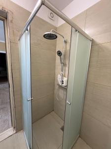 a shower with a glass door in a bathroom at Durres-apartament in Durrës