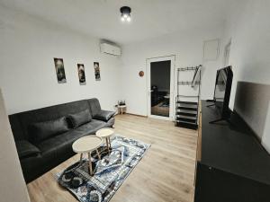 a living room with a couch and a table at Hikers place in Sutomore