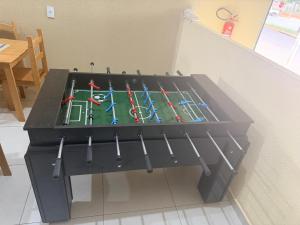 a table with hockey sticks on it in a room at Hotel ideal 2 in Inocência