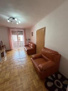 a living room with two chairs and a couch at GZP Residence Lugoj 2 in Lugoj