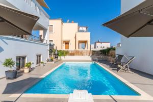 a swimming pool in the backyard of a house at Villa Gagra - Villa by the Sea with a Private Pool in Panormos Rethymno
