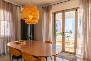 a dining room with a table and chairs and a window at Villa Gagra - Villa by the Sea with a Private Pool in Panormos Rethymno
