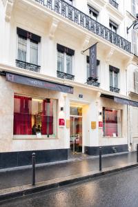 a store front of a building on a street at Hotel Migny Opéra Montmartre in Paris