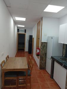 a kitchen with a table and chairs in a room at Apartmento El Descanso in Rincón de Soto