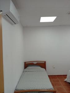 a bed in a white room with a ceiling at Apartmento El Descanso in Rincón de Soto