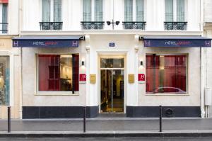 a store front of a building on a city street at Hotel Migny Opéra Montmartre in Paris