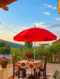 a red umbrella sitting on top of a table at Home Lin in Lin