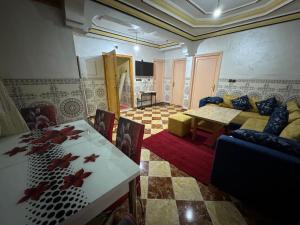 a living room with a couch and a table at Omarkad in Taourirt