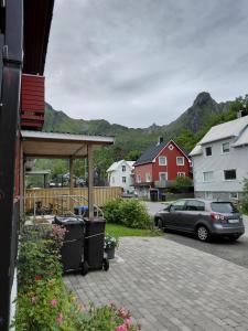a backyard with a bbq and a car parked at Siva's Apartment in Svolvær