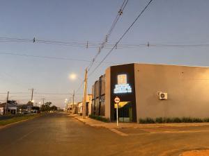 an empty street with a sign on the side of a building at Hotel ideal 2 in Inocência