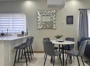 a kitchen with a table and chairs and a counter at Villa cool breeze in Steer Town