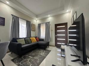 a living room with a couch and a television at Villa cool breeze in Steer Town