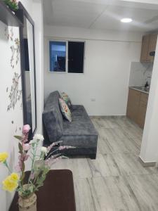 a living room with a couch in a room at Donde poyito in Sevilla +17 photos