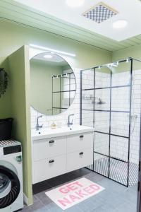 a bathroom with a sink and a mirror at MiHome - Grimming View Apartment in Tauplitz +43 photos