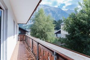 a balcony with a view of a mountain at MiHome - Grimming View Apartment in Tauplitz