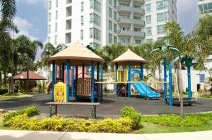 a playground in a park in front of a building at The Residences at Puri Casablanca in Jakarta