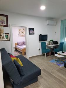 a living room with a couch and a bedroom at Apartman Jass in Stari Banovci