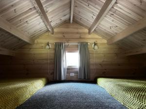 a bedroom with two beds and a window at Kregžlės slėnis in Skirlėnai +33 photos