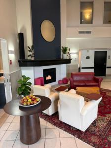 a living room with a table and a fireplace at Hôtel TERRA Laurentides in Sainte-Agathe-des-Monts