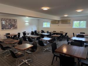 an empty classroom with tables and chairs in it at Hôtel TERRA Laurentides in Sainte-Agathe-des-Monts +29 photos