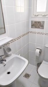 a bathroom with a sink and a toilet at MBZ - Boutique Bed Space in Muşaffaḩ
