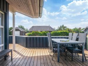 a patio with a table and chairs on a deck at 4 star holiday home in Tarm in Tarm