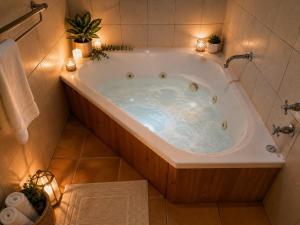 a bath tub with lights in a bathroom at Coonawarra Place Motor Inn in Coonawarra +23 photos