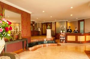 a lobby with a hair salon with two people at The Residences at Puri Casablanca in Jakarta