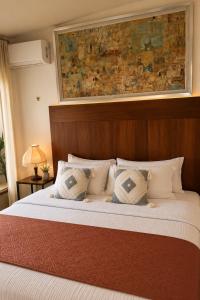 a bedroom with a large bed with a wooden headboard at Apartment with jacuzzi and beach club access in Telchac Puerto +27 photos