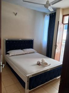 a bedroom with a bed with a camera on it at Lex homes in Mombasa