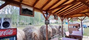 a pavilion with a coke machine and hay bales at Camper Park Lake View in Mëmëlisht
