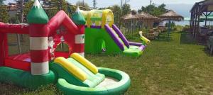 a small playground with a slide in the grass at Camper Park Lake View in Mëmëlisht