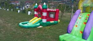 a childs playground with a play equipment in the grass at Camper Park Lake View in Mëmëlisht