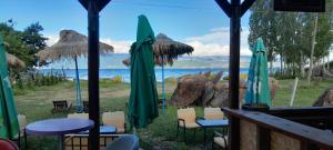 a view of the ocean from a restaurant with chairs and umbrellas at Camper Park Lake View in Mëmëlisht