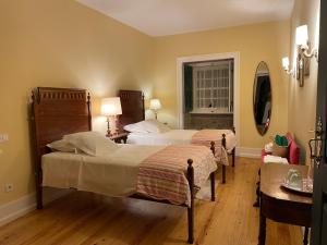 a hotel room with two beds and a mirror at Casa da Agrela in Ponte da Barca +82 photos