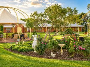a garden with a statue of a rabbit in a yard at Coonawarra Place Motor Inn in Coonawarra