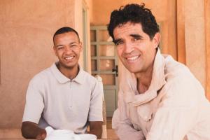 two men sitting at a table with a vase at Maison d'Hôtes Irocha in Tisseldeï +242 photos