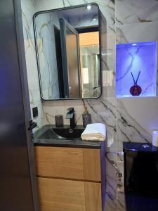 a bathroom with a sink and a mirror at Ikamat raha in Tangier