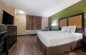 a hotel room with a bed and a flat screen tv at Extended Stay America Suites - San Jose - Edenvale - North in Coyote