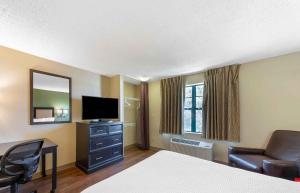 a hotel room with a bed a desk and a television at Extended Stay America Suites - Los Angeles - Torrance - Del Amo Circle in Torrance