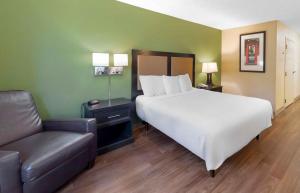 a bedroom with a large bed and a chair at Extended Stay America Suites - Los Angeles - Torrance - Del Amo Circle in Torrance
