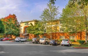 a building with cars parked in a parking lot at Extended Stay America Suites - Seattle - Bothell - Canyon Park in Bothell