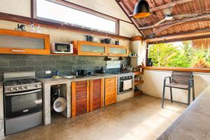 a kitchen with wooden cabinets and a stove top oven at Casa Swell Coronado, Adults-Only Boutique Hotel, Pool & Beach in Playa Coronado +95 photos