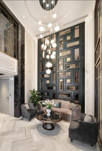 a living room with a couch and a table at LP Hotel & Spa Pham Hong Thai in Hanoi +8 photos