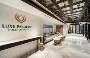 a lobby of a luxury hotel with a sign that reads lake paradise premium hotel at LP Hotel & Spa Pham Hong Thai in Hanoi