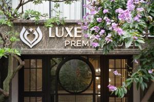 a sign over a door with purple flowers at LP Hotel & Spa Pham Hong Thai in Hanoi