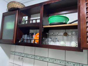 a kitchen cabinet filled with lots of glass jars at La pépite de Joelle in Douala +35 photos