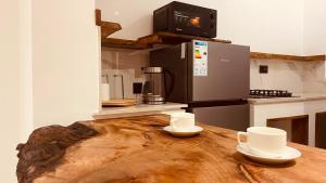 a kitchen with a wooden table with two cups on it at Maison Studio indépendante in Nungwi +22 photos